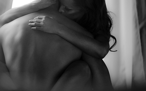 Sexy young couple kissing and playing in bed.